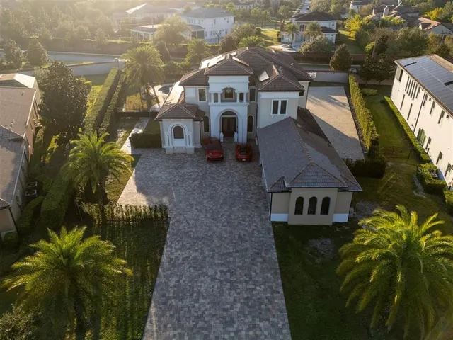 a living room with furniture a fireplace and chandelier