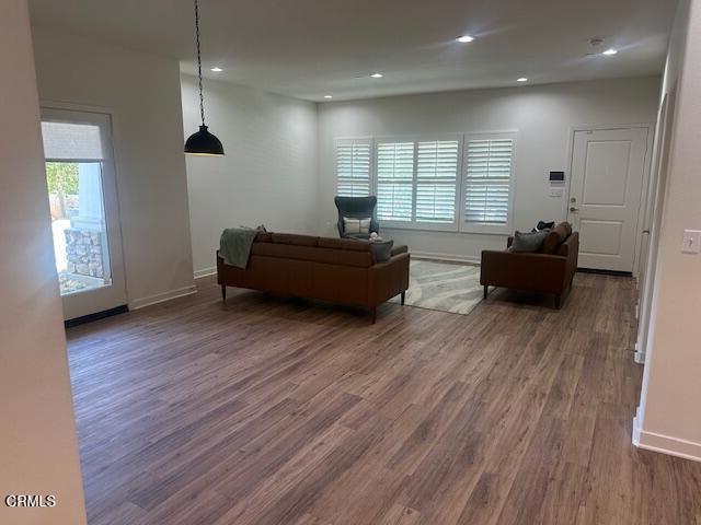 307 North F Street, Unit 102 Oxnard, CA 93030 - Photo 12 of 12 a living room with furniture and wooden floor