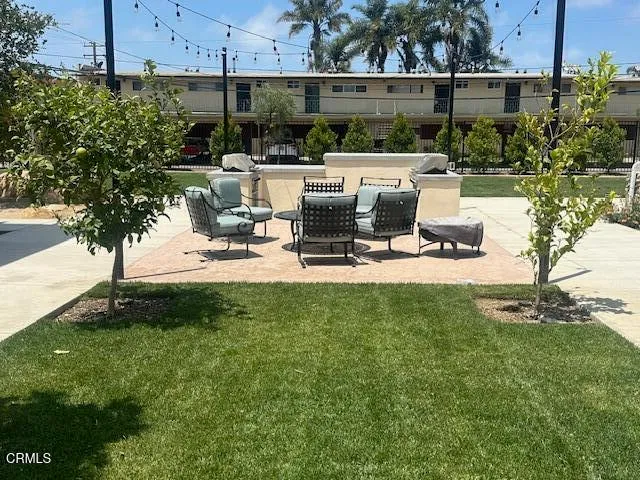 a view of a backyard with sitting area