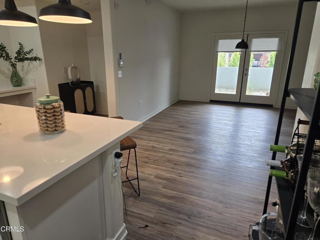 307 North F Street, Unit 102 Oxnard, CA 93030 - Photo 6 of 12 a view of a hallway with wooden floor and staircase