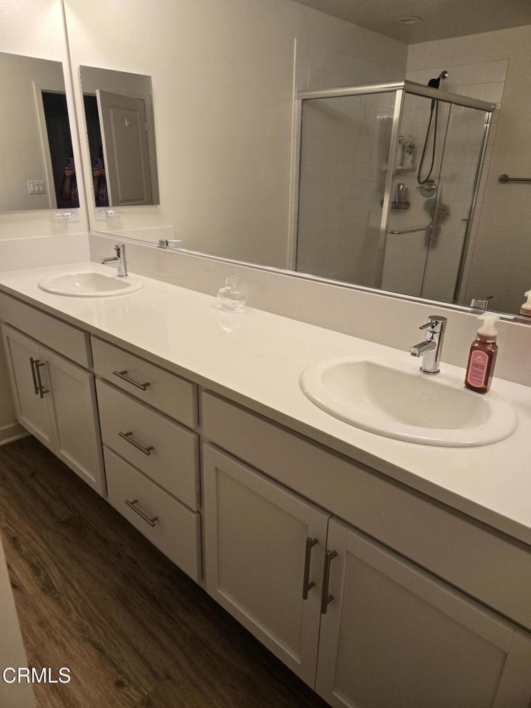 307 North F Street, Unit 102 Oxnard, CA 93030 - Photo 9 of 12 a bathroom with a sink and a mirror