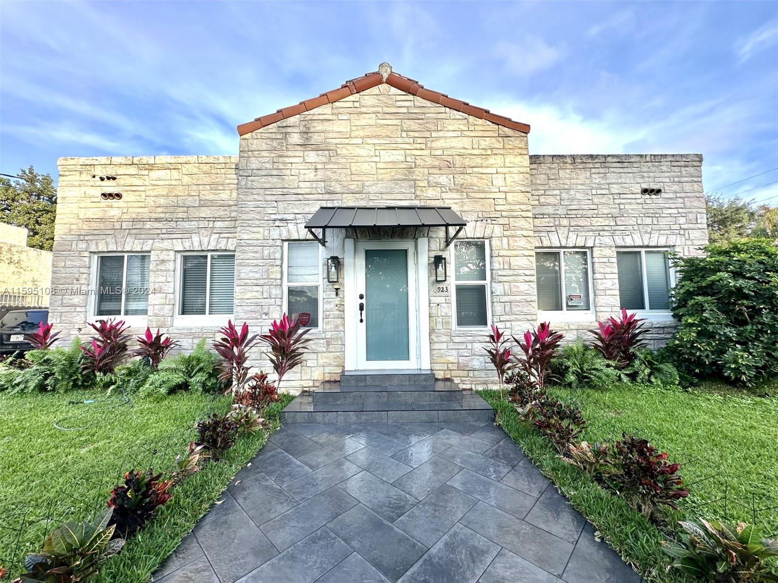 a front view of house with the garden