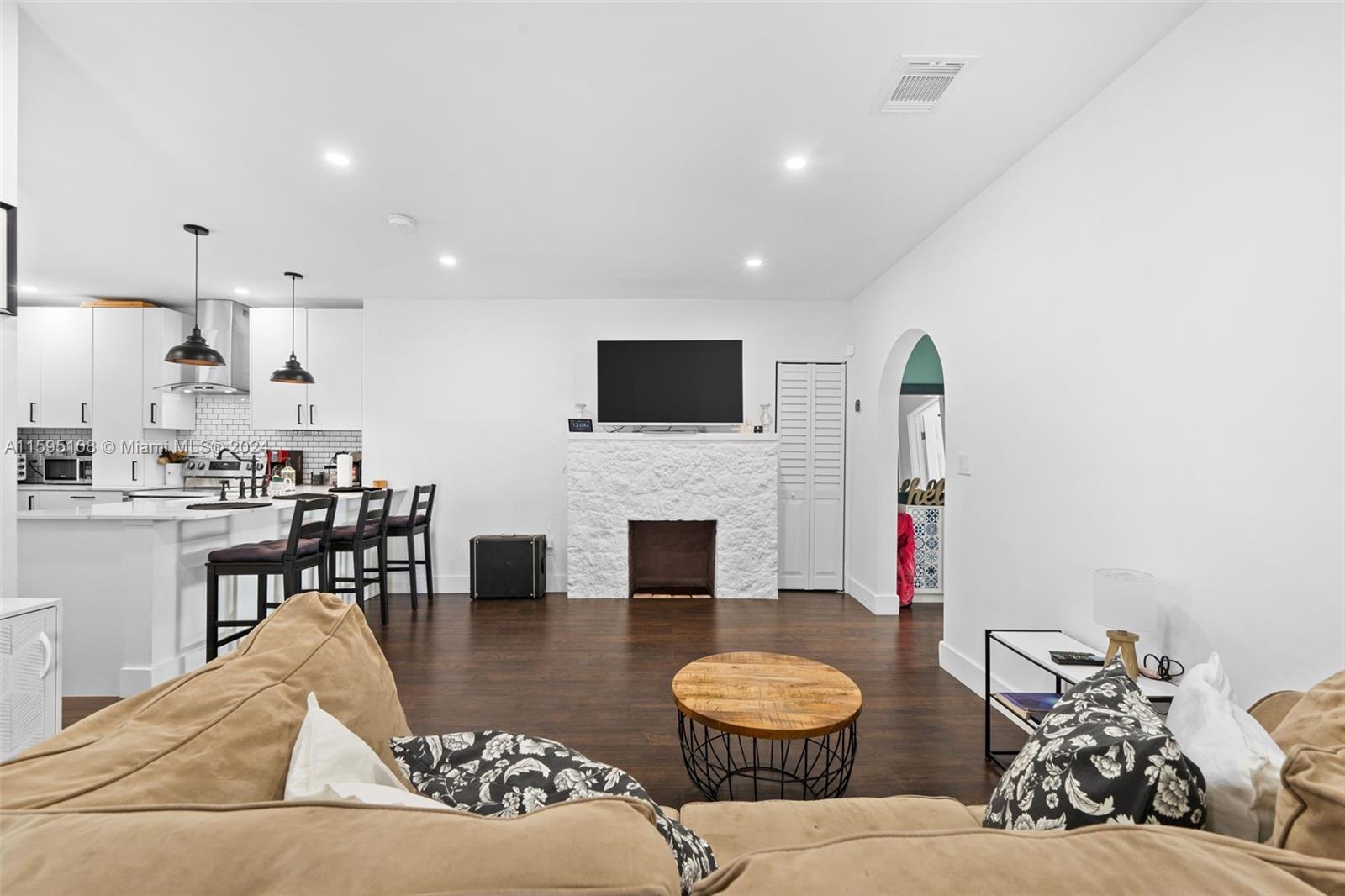 923 Southwest 13th Court Miami, FL 33135 - Photo 11 of 58 a living room with furniture and a fireplace