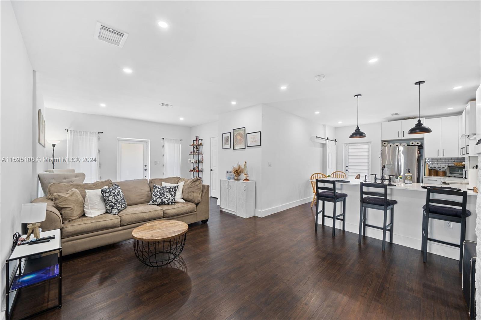 923 Southwest 13th Court Miami, FL 33135 - Photo 12 of 58 a living room with furniture and a wooden floor