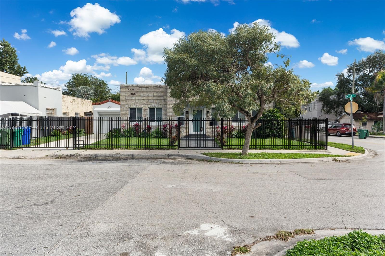 923 Southwest 13th Court Miami, FL 33135 - Photo 2 of 58 a view of a house with a big yard and large trees