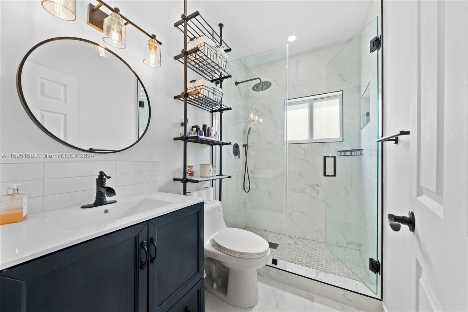 923 Southwest 13th Court Miami, FL 33135 - Photo 27 of 58 a bathroom with a sink a toilet and shower