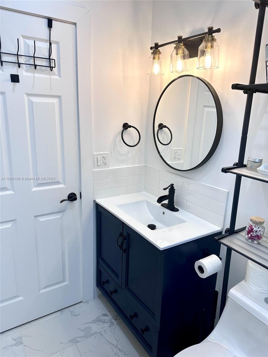 923 Southwest 13th Court Miami, FL 33135 - Photo 28 of 58 a bathroom with a sink and a mirror