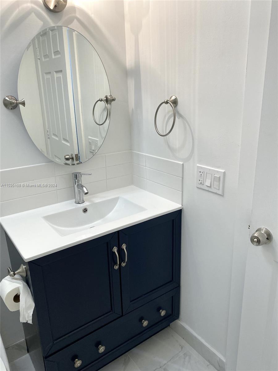 923 Southwest 13th Court Miami, FL 33135 - Photo 36 of 58 a bathroom with a sink vanity and mirror