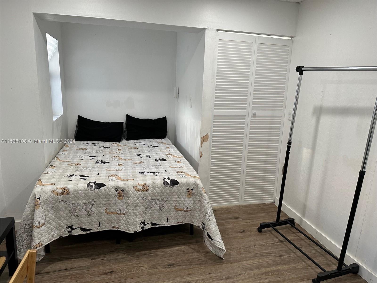 923 Southwest 13th Court Miami, FL 33135 - Photo 38 of 58 a bedroom with a bed and a mirror