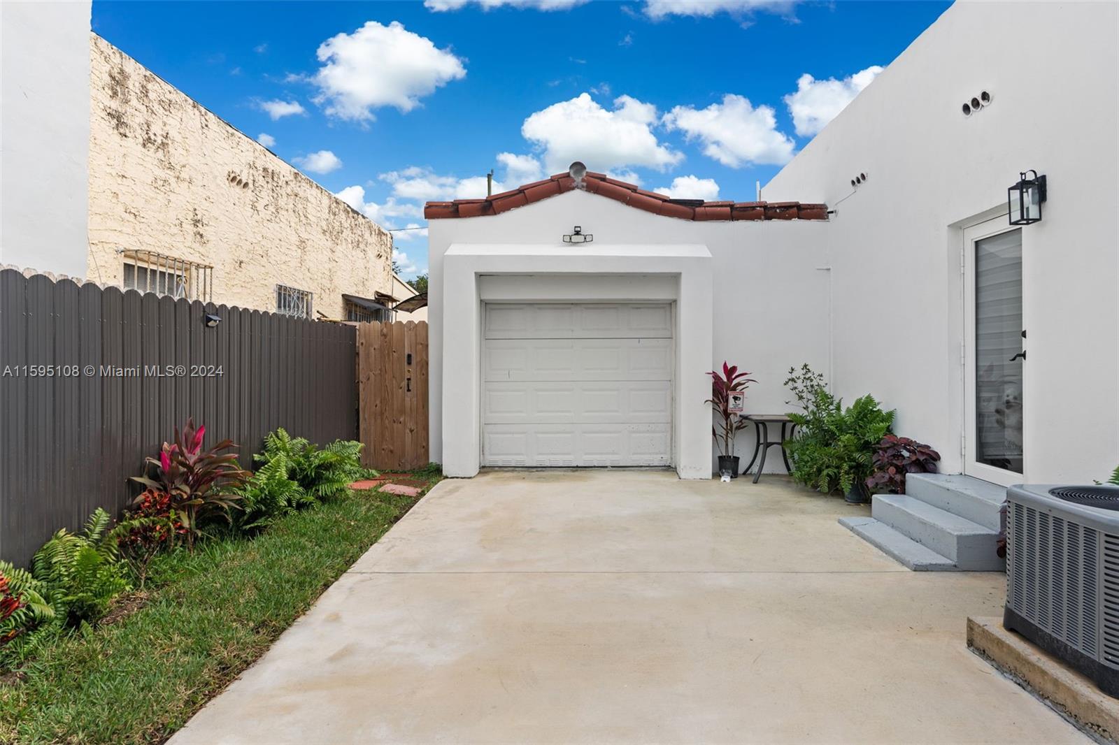923 Southwest 13th Court Miami, FL 33135 - Photo 5 of 58 a view of a house with a small yard and potted plants