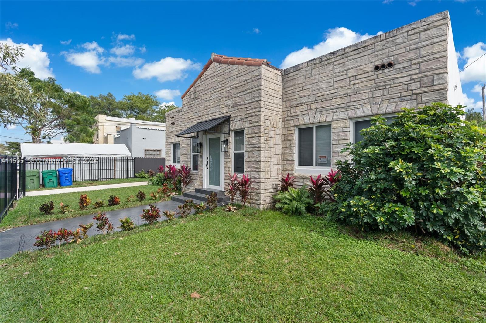 923 Southwest 13th Court Miami, FL 33135 - Photo 7 of 58 a front view of a house with a garden and plants