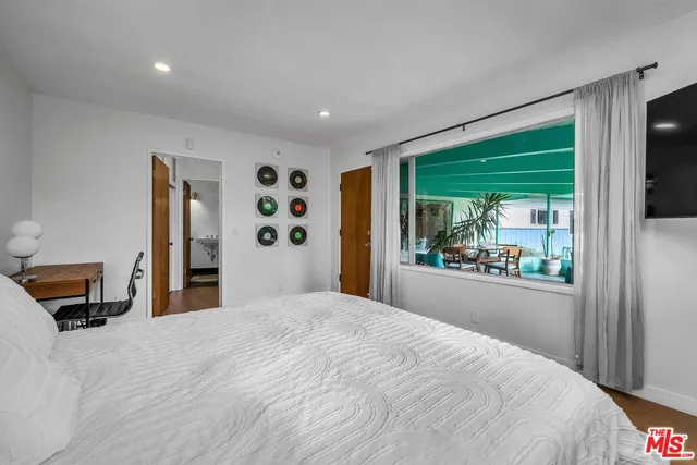 a bedroom with a large bed and a window