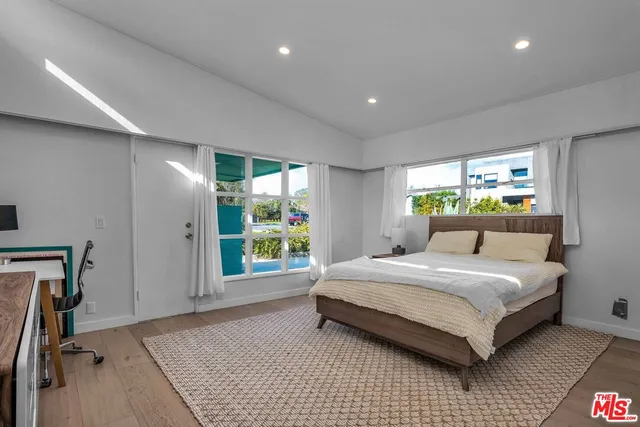 a bedroom with a large bed and a window