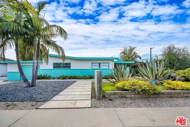 a front view of a house with a big yard