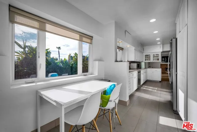 a kitchen with refrigerator and furniture