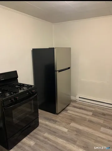 a kitchen with a refrigerator stove and cabinets