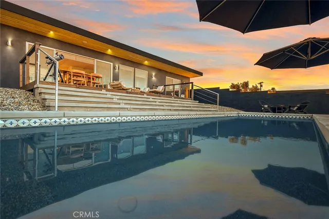 a view of a house with a yard and sitting area