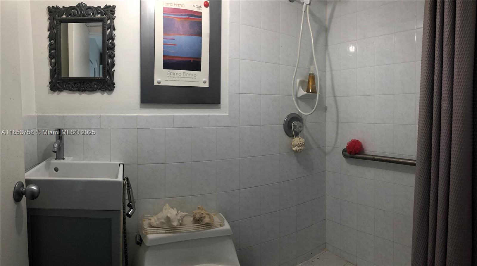 1619 Southwest 13th Street Miami, FL 33145 - Photo 17 of 46 a bathroom with a sink and a mirror