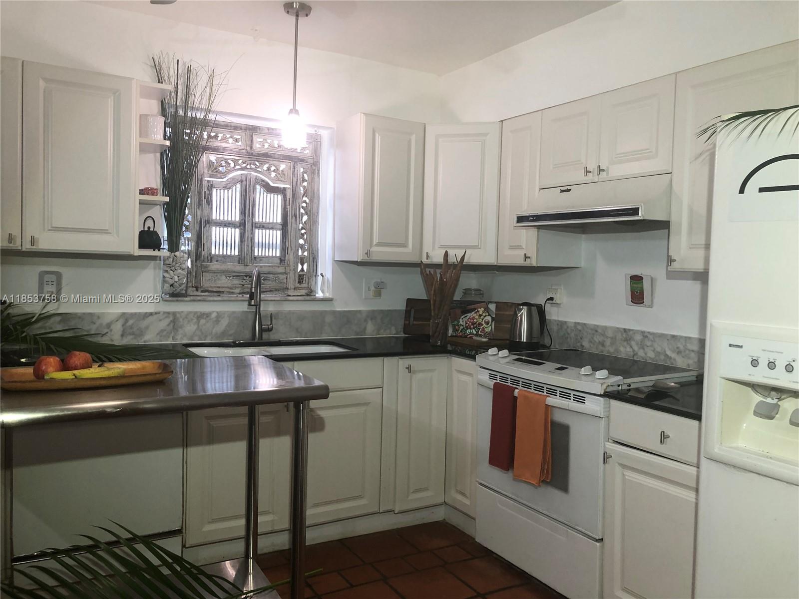 1619 Southwest 13th Street Miami, FL 33145 - Photo 18 of 46 a kitchen with stainless steel appliances granite countertop a sink stove and cabinets