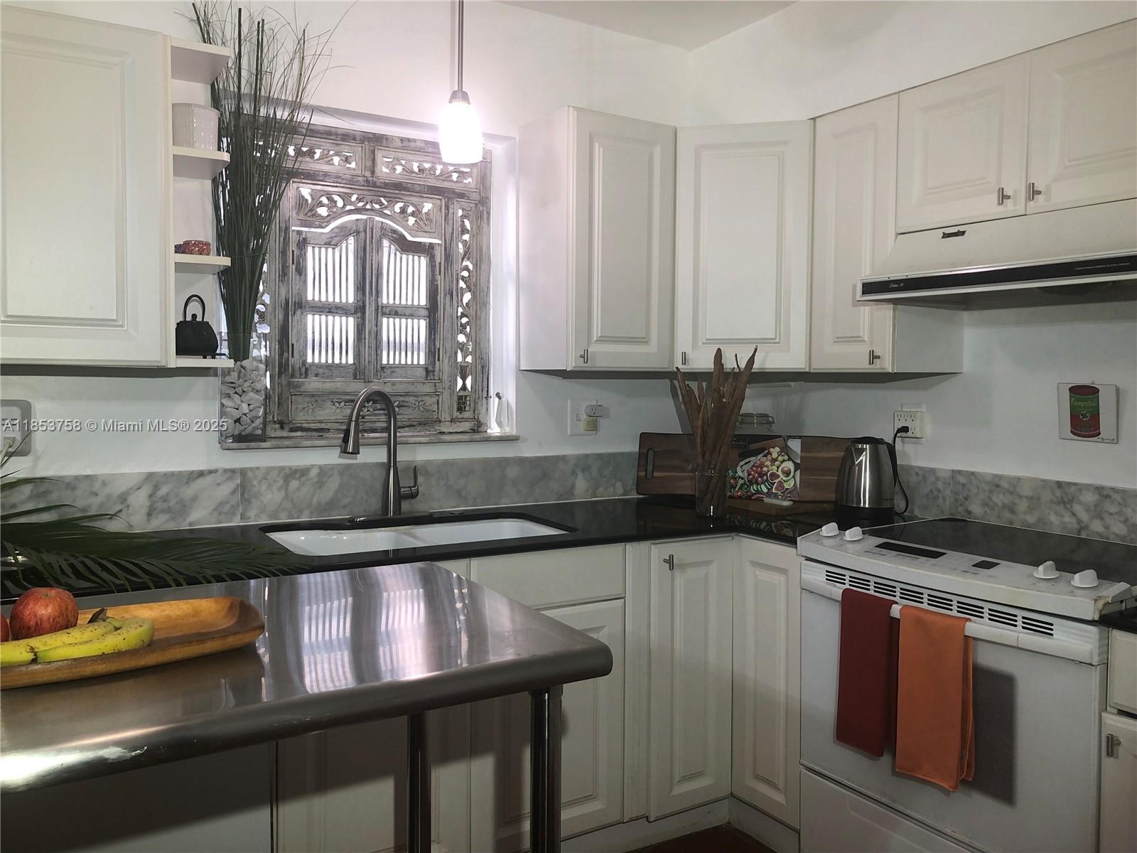 1619 Southwest 13th Street Miami, FL 33145 - Photo 20 of 46 a kitchen with granite countertop a sink stove and cabinets