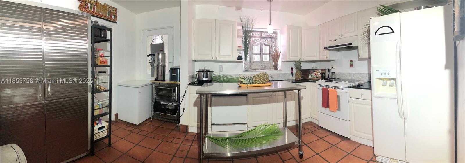1619 Southwest 13th Street Miami, FL 33145 - Photo 21 of 46 a kitchen with a sink a stove a refrigerator and cabinets