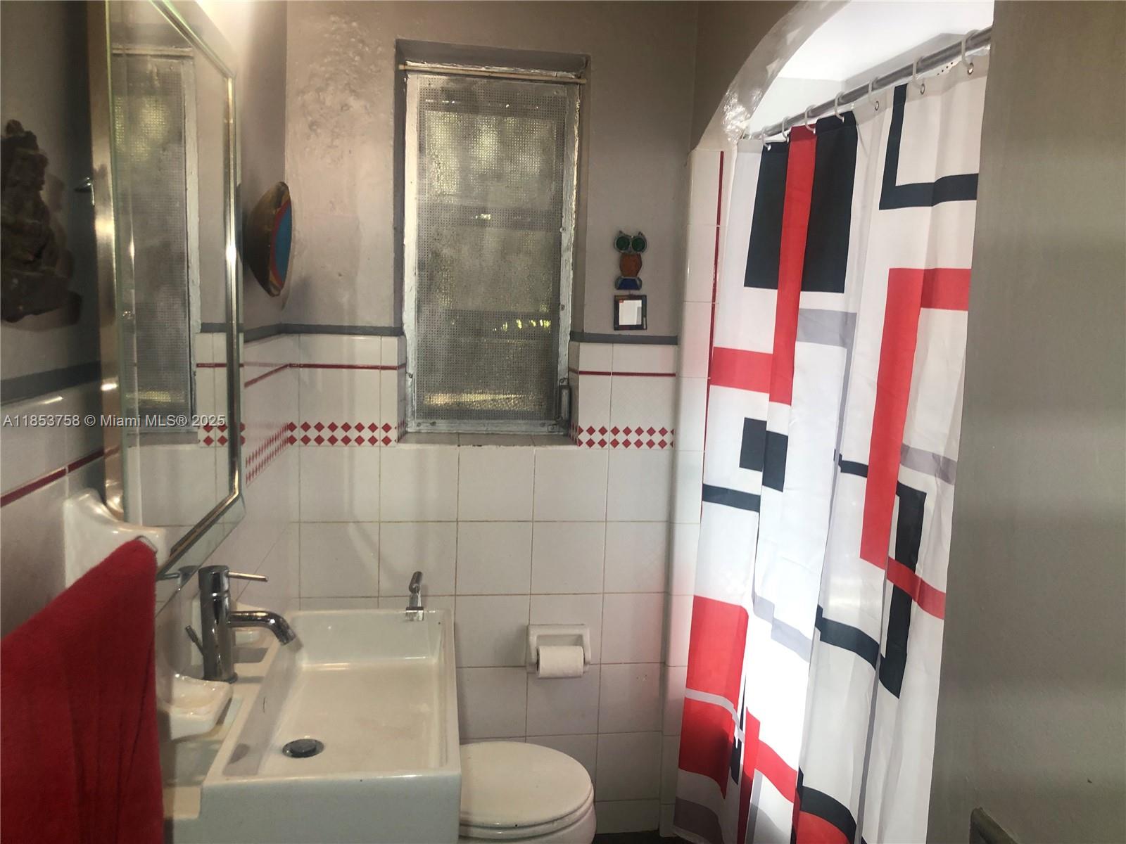 1619 Southwest 13th Street Miami, FL 33145 - Photo 26 of 46 a bathroom with a sink and mirror with toilet