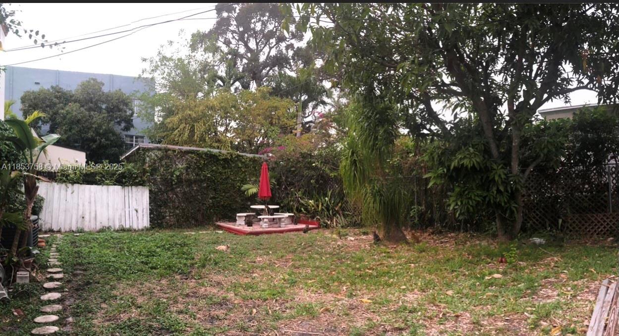 1619 Southwest 13th Street Miami, FL 33145 - Photo 45 of 46 a backyard of a house with table and chairs