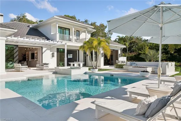 a view of a patio with swimming pool table and chairs