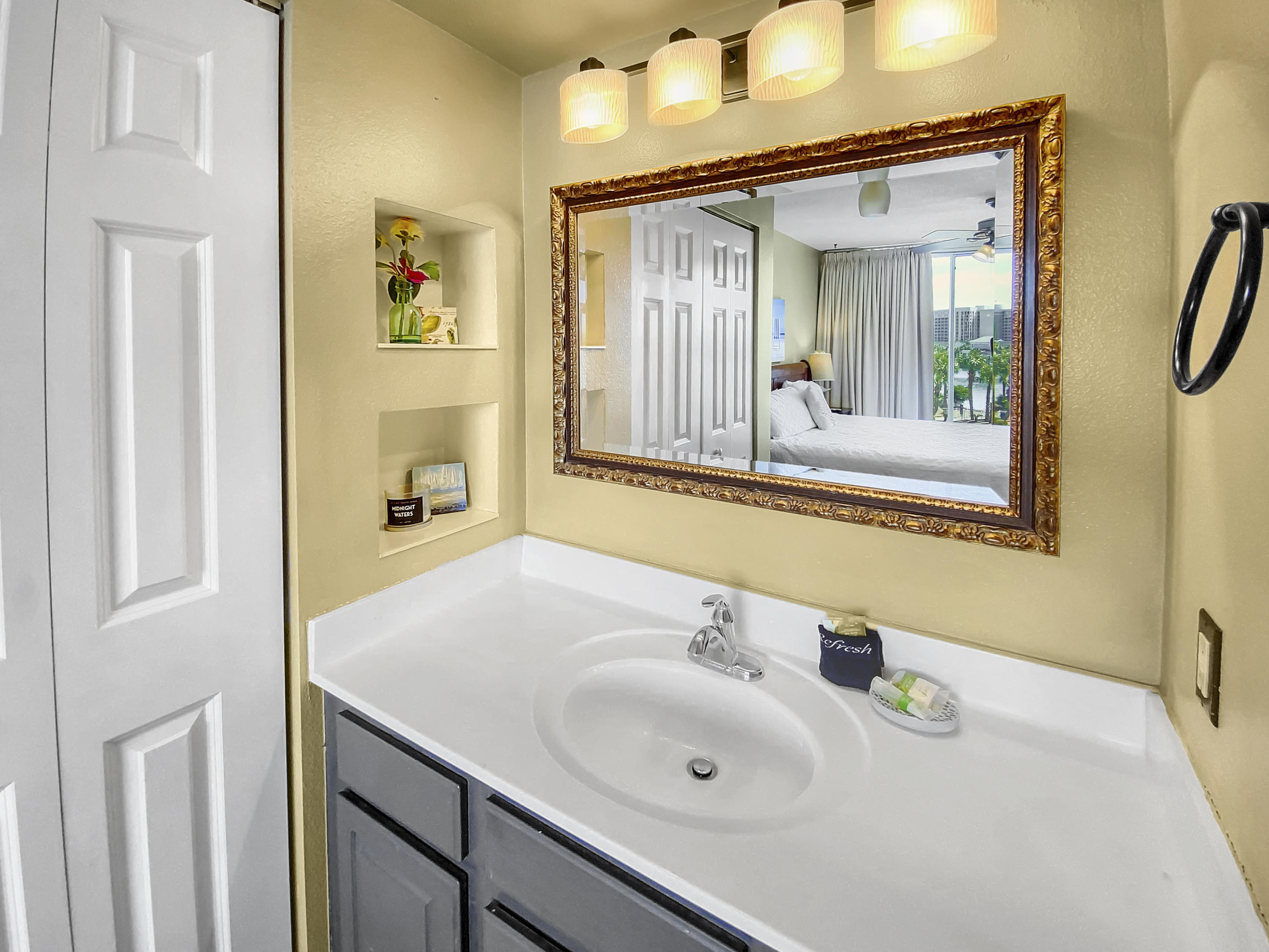 970 Highway 98, Unit 206 Destin, FL 32541 - Photo 11 of 25 a bathroom with a sink and a mirror