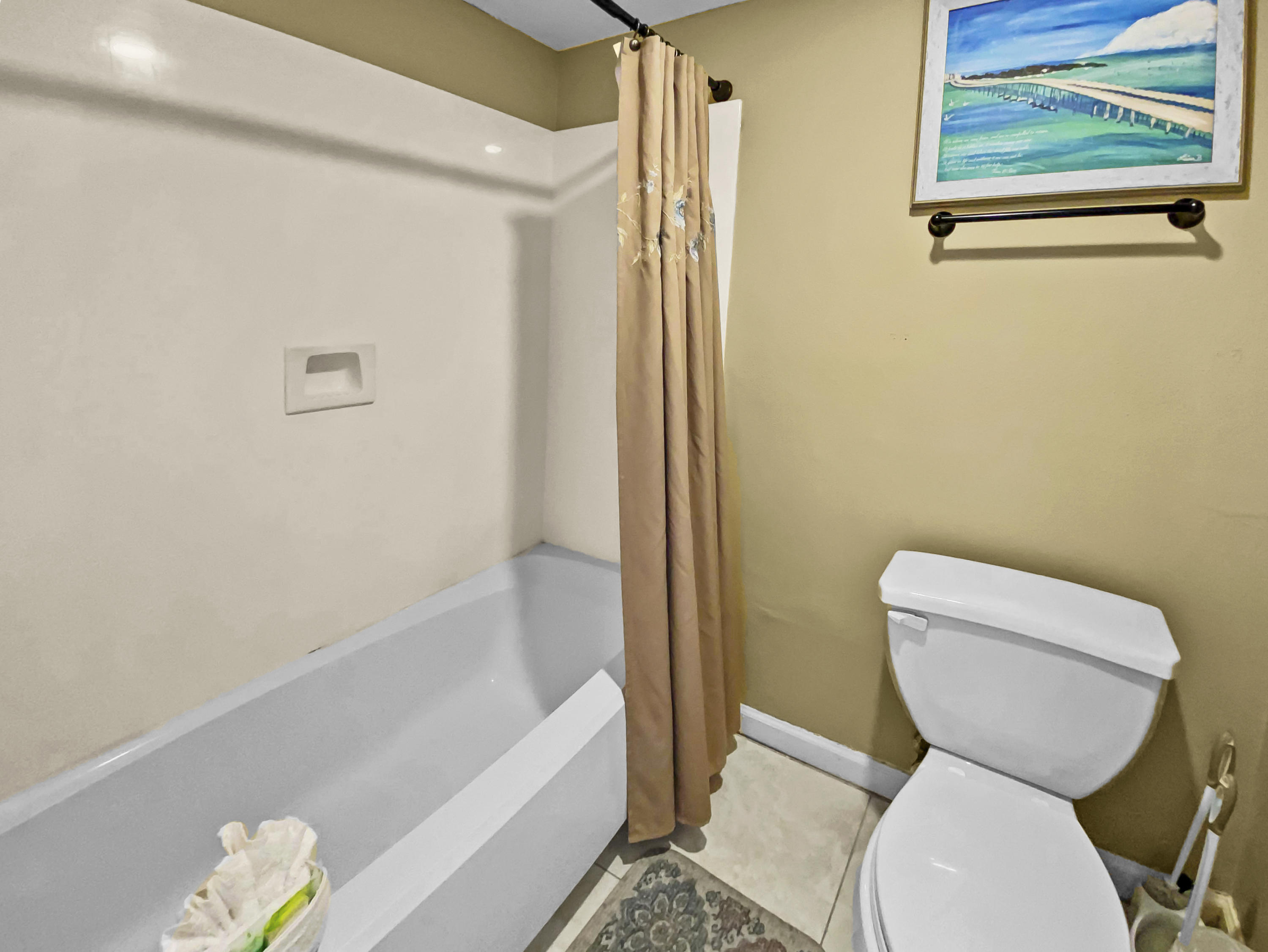 970 Highway 98, Unit 206 Destin, FL 32541 - Photo 12 of 25 a bathroom with a toilet and bathtub