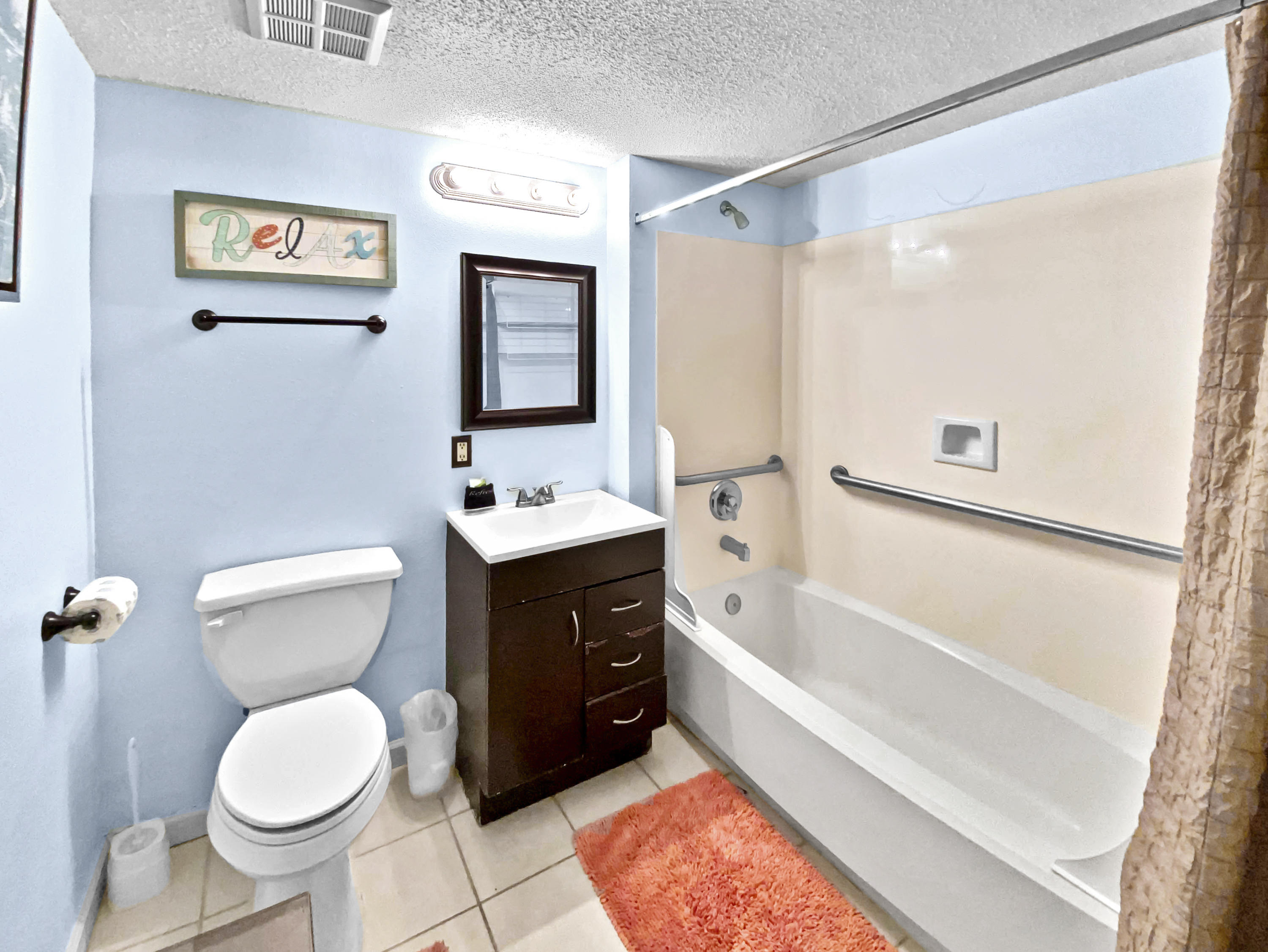 970 Highway 98, Unit 206 Destin, FL 32541 - Photo 15 of 25 a bathroom with a toilet sink and mirror