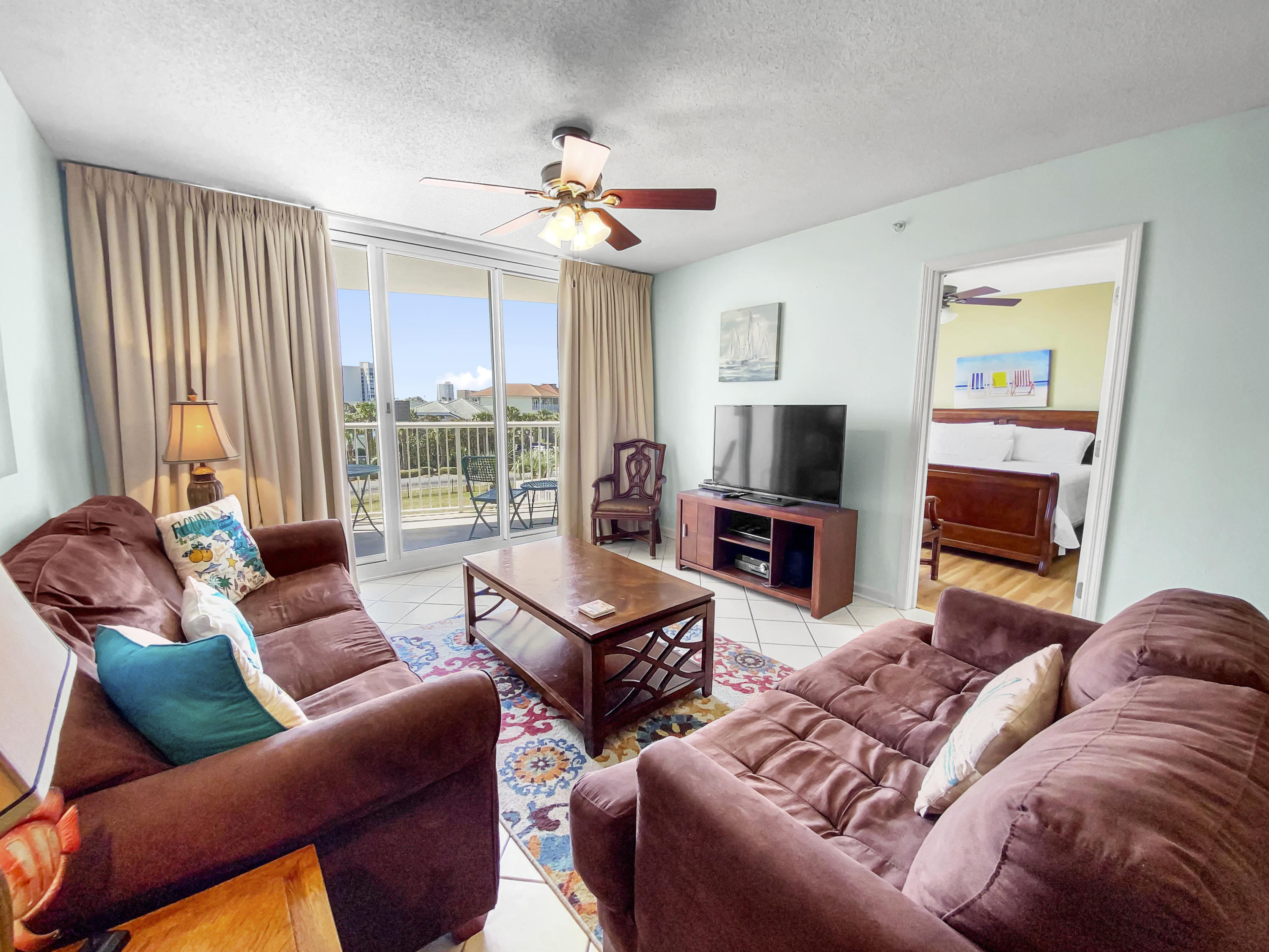970 Highway 98, Unit 206 Destin, FL 32541 - Photo 5 of 25 a living room with furniture a flat screen tv and a window