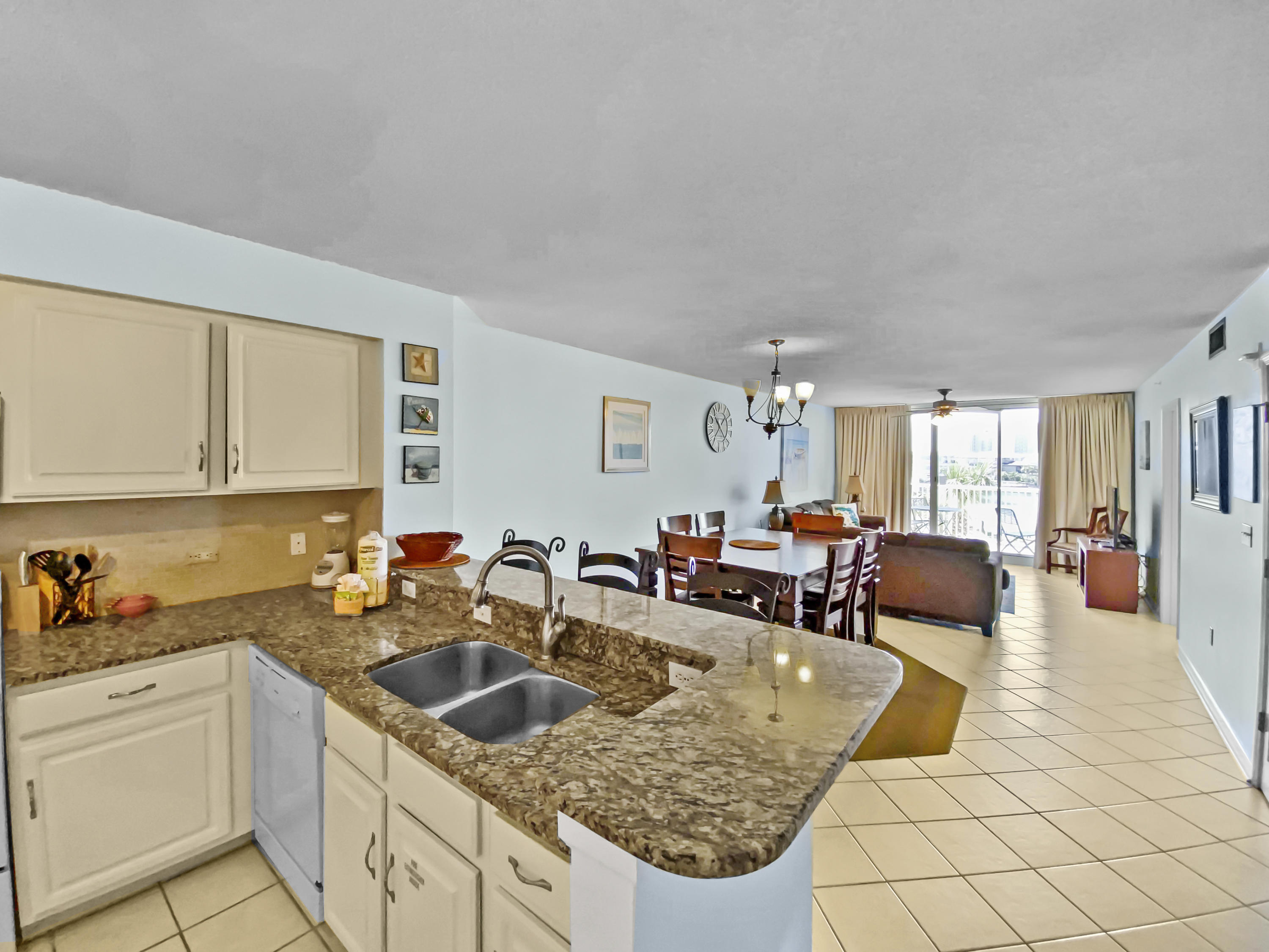970 Highway 98, Unit 206 Destin, FL 32541 - Photo 6 of 25 a kitchen with stainless steel appliances granite countertop a sink dishwasher and cabinets with wooden floor