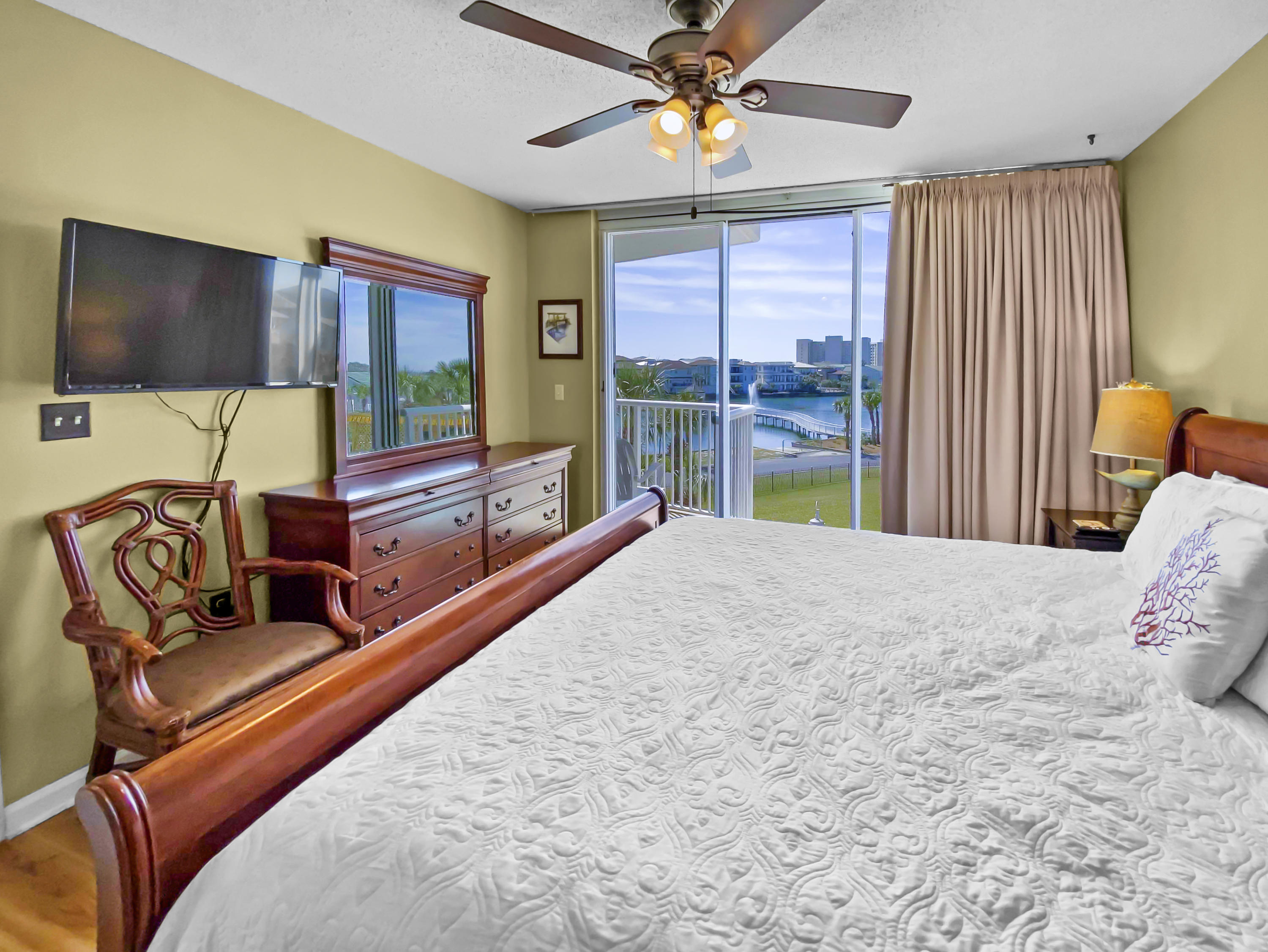 970 Highway 98, Unit 206 Destin, FL 32541 - Photo 10 of 25 a bedroom with a bed and glass wall