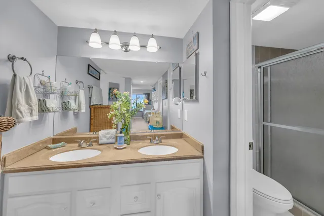 a bathroom with a sink a toilet and a mirror