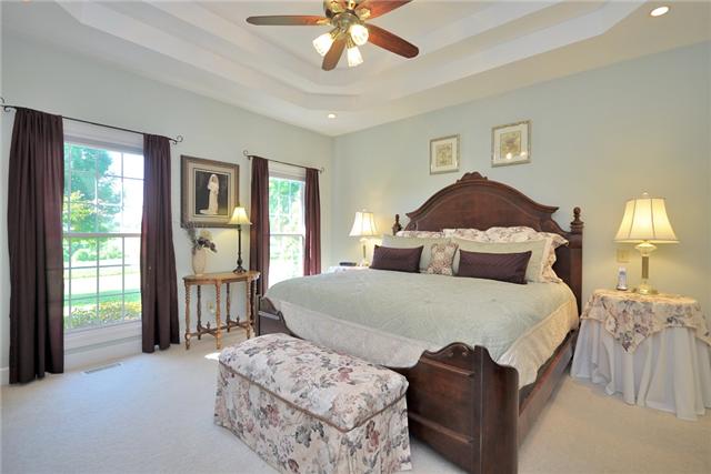 4845 Hickory Ridge Road Lebanon, TN 37087 - Photo 14 of 20 a bedroom with a bed and a chandelier