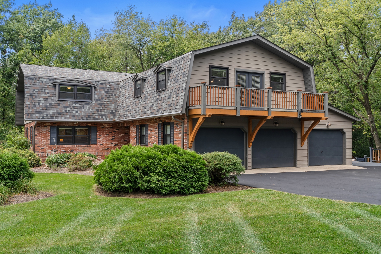 a front view of a house with a garden and plants