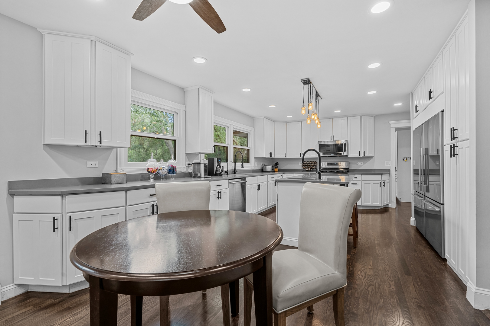 906 Bridle Lane Cary, IL 60013 - Photo 17 of 61 a kitchen with kitchen island granite countertop a sink a center island and stainless steel appliances