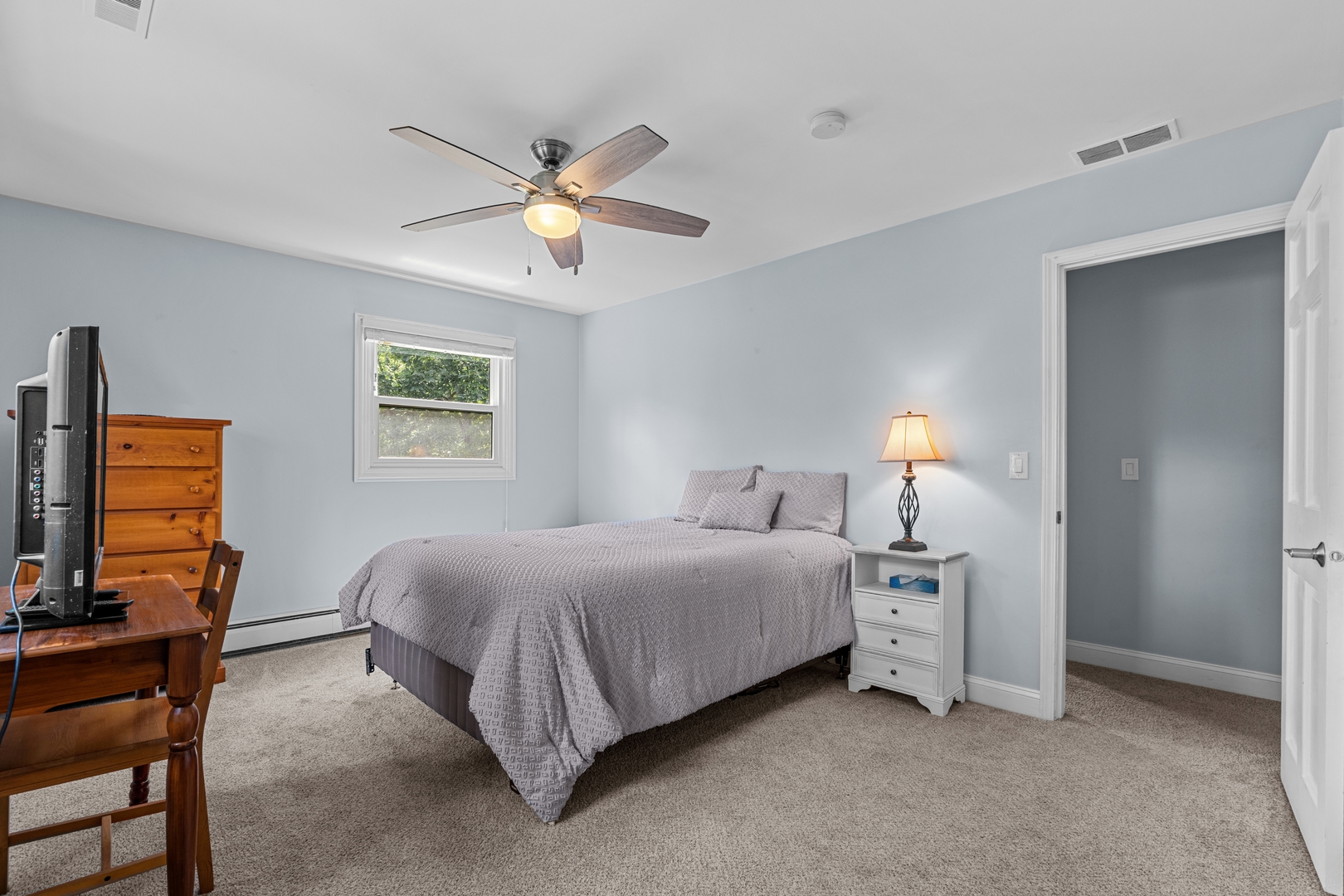 906 Bridle Lane Cary, IL 60013 - Photo 34 of 61 a bedroom with a bed a chandelier and a couch