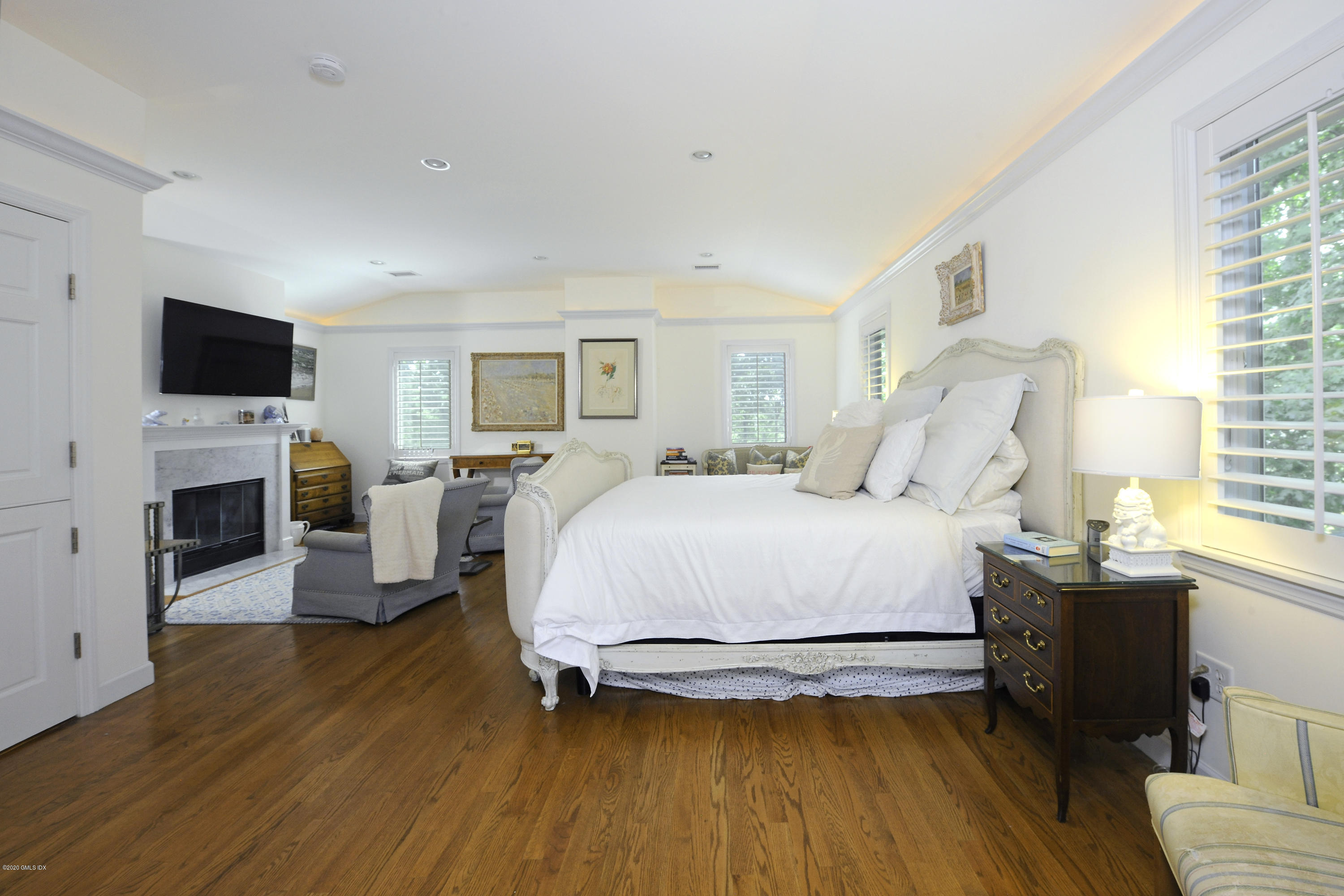 19 Gregory Road Cos Cob, CT 06807 - Photo 13 of 22 a spacious bedroom with a bed and a flat screen tv