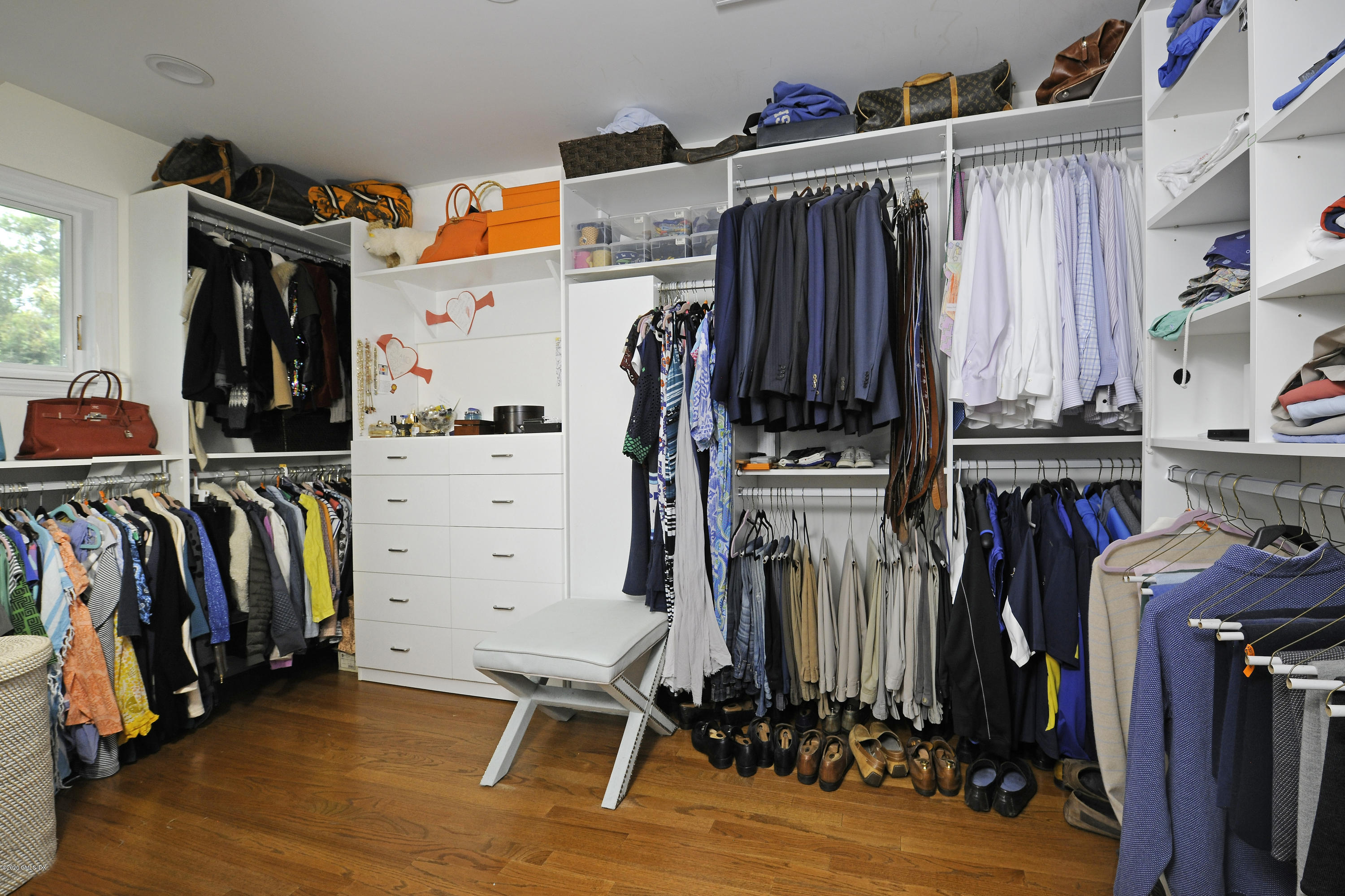 19 Gregory Road Cos Cob, CT 06807 - Photo 15 of 22 a view of walk in closet with clothes and shoes