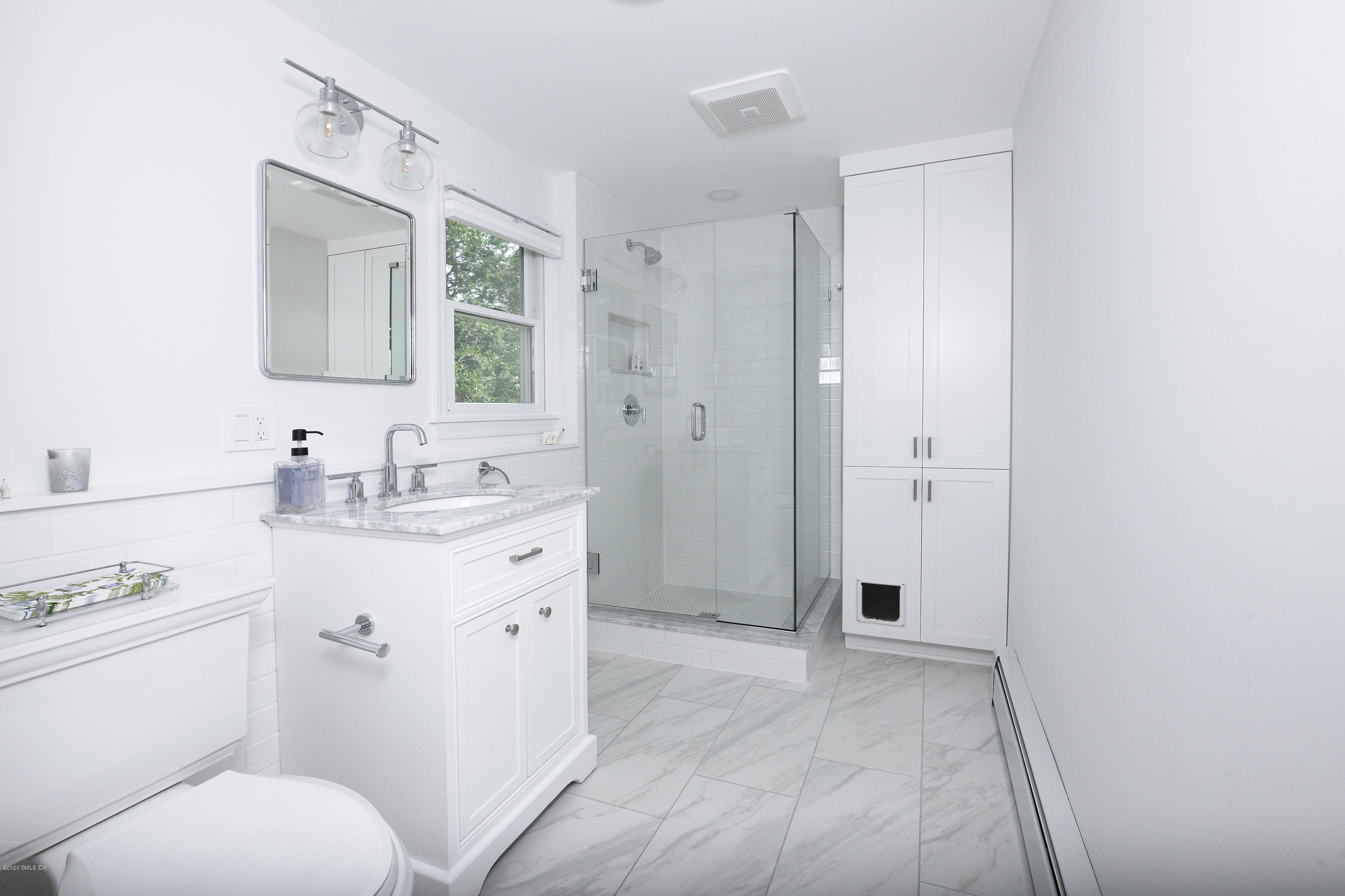 19 Gregory Road Cos Cob, CT 06807 - Photo 19 of 22 a spacious bathroom with a granite countertop sink toilet a mirror and vanity