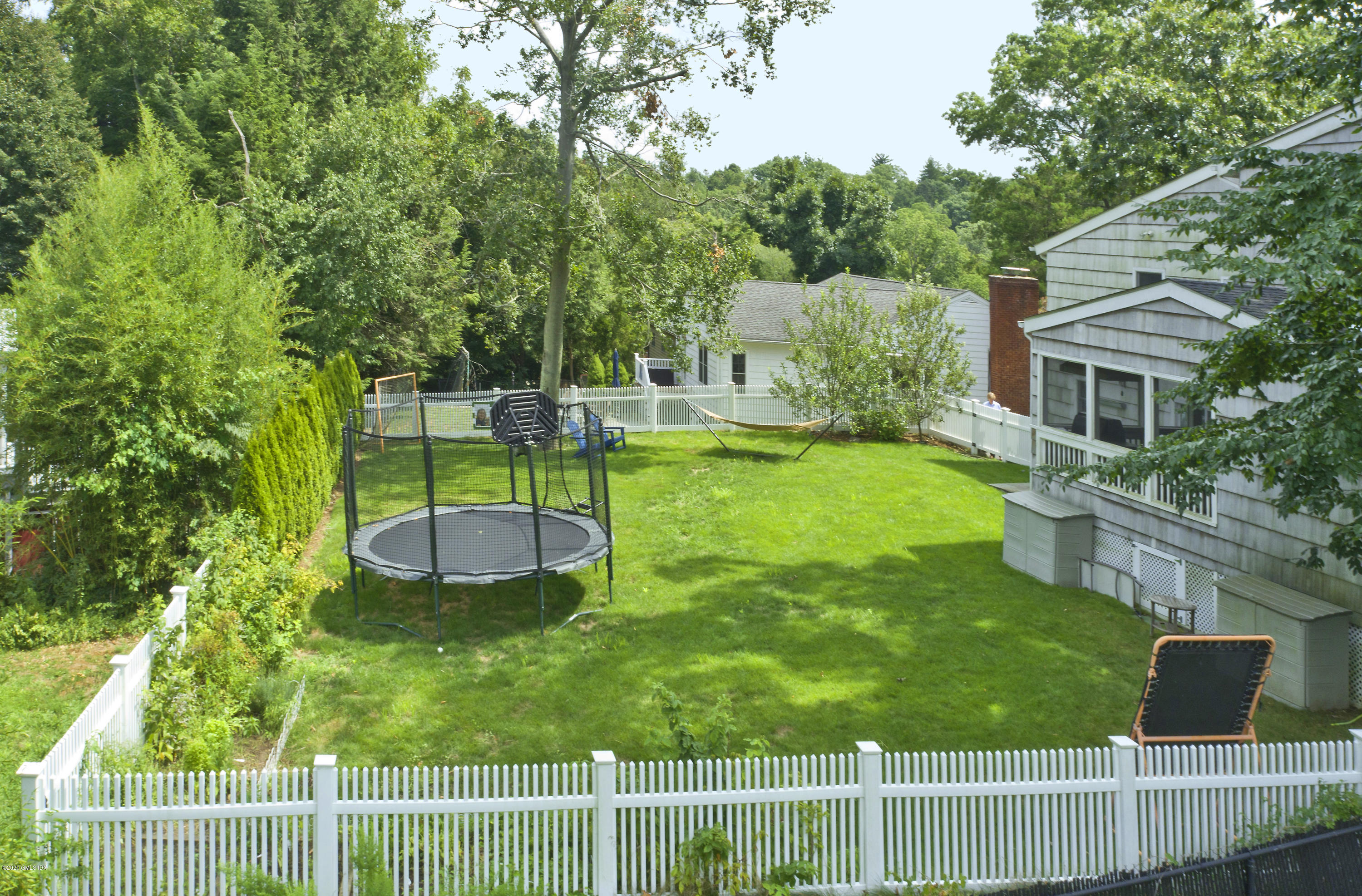 19 Gregory Road Cos Cob, CT 06807 - Photo 3 of 22 a view of a house with backyard and a hammock