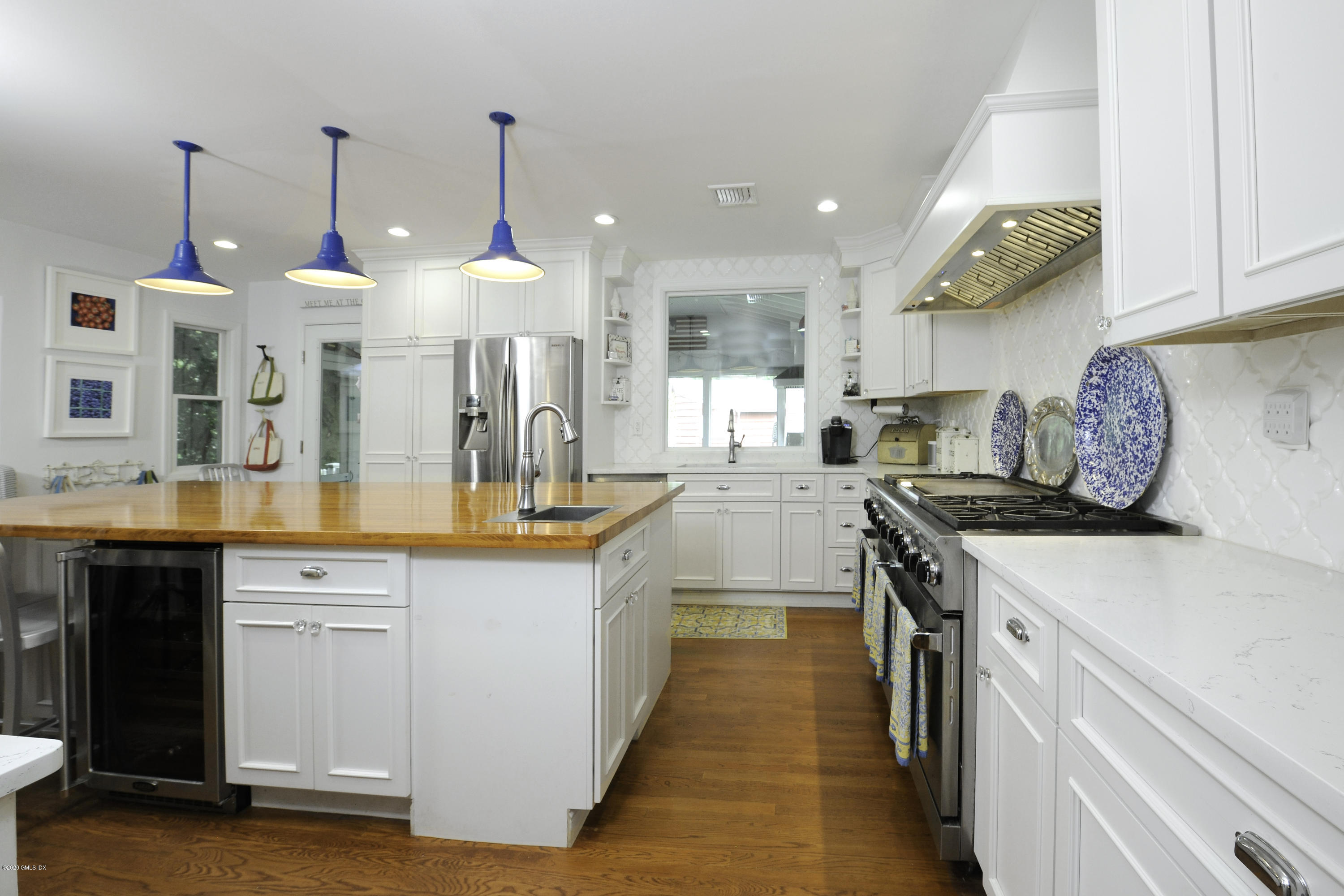 19 Gregory Road Cos Cob, CT 06807 - Photo 8 of 22 a kitchen with stainless steel appliances granite countertop a stove a sink and a wooden floors