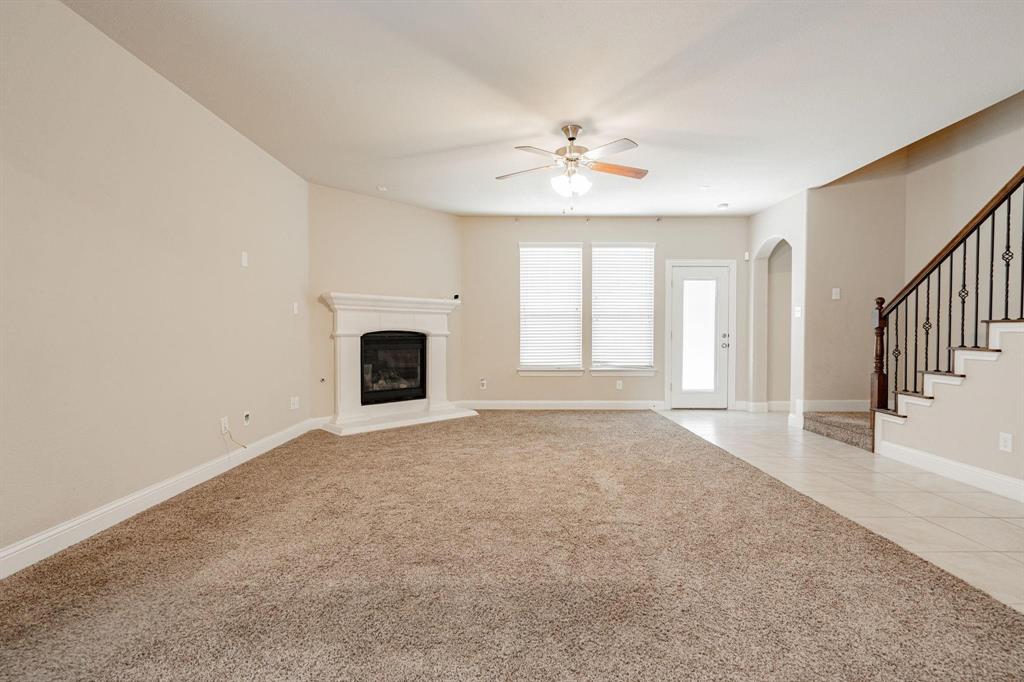 529 England Street Fate, TX 75189 - Photo 5 of 11 an empty room with windows and fireplace