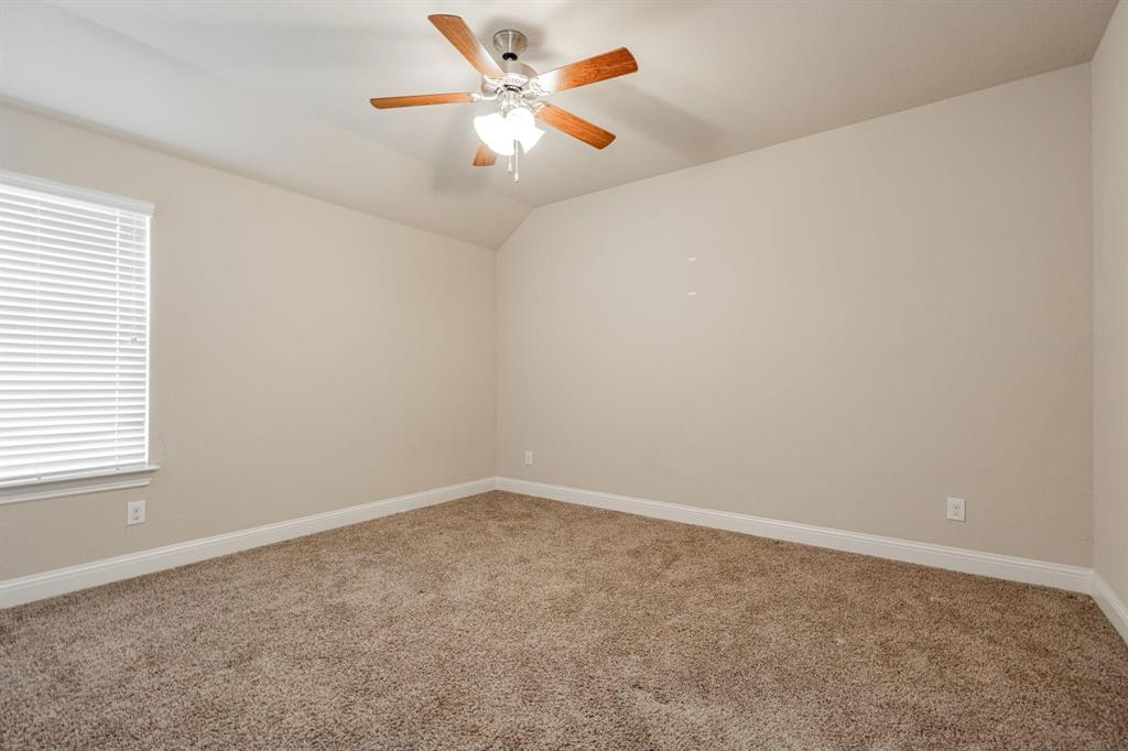 529 England Street Fate, TX 75189 - Photo 7 of 11 an empty room with a window and a fan