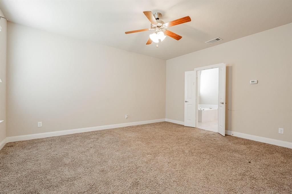 529 England Street Fate, TX 75189 - Photo 9 of 11 an empty room with a ceiling fan and a window
