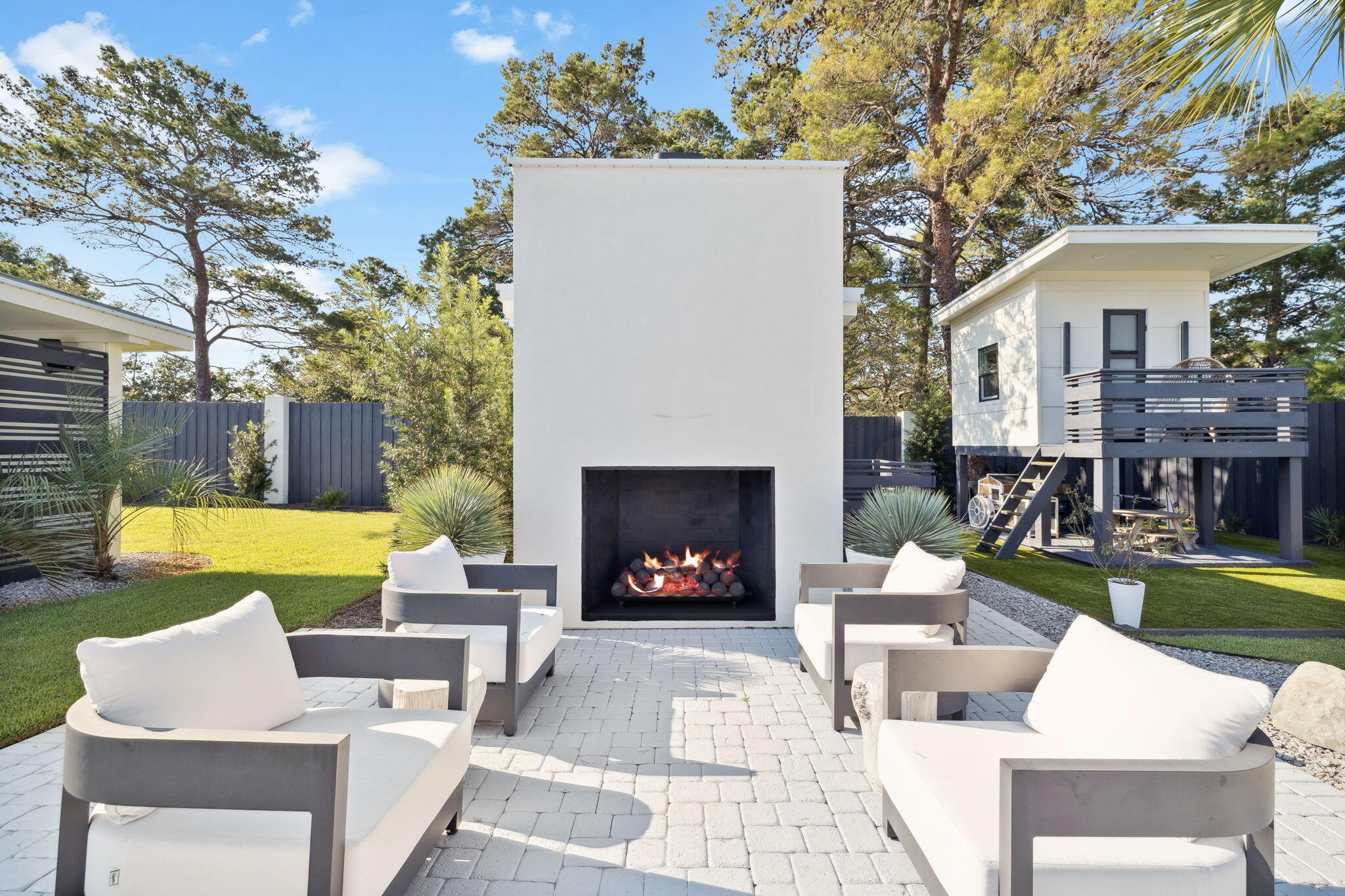 114 Surfside Drive Santa Rosa Beach, FL 32459 - Photo 25 of 45 a view of a patio with couches and a fire pit and a yard