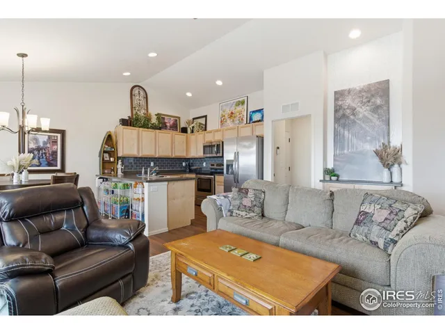 a living room with furniture and kitchen view
