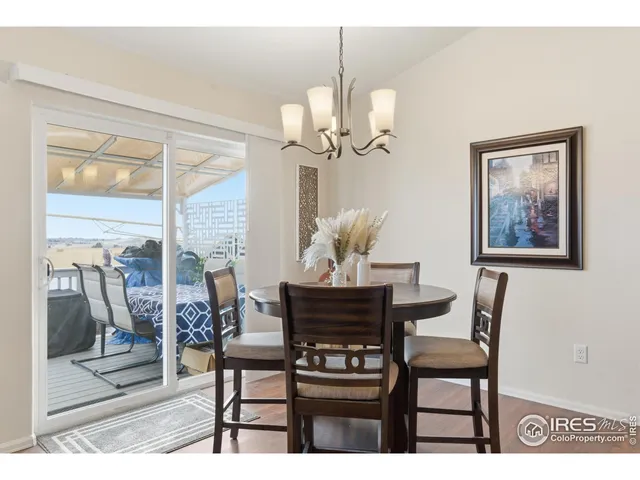 a view of a dining room with furniture wooden floor and a chandelier